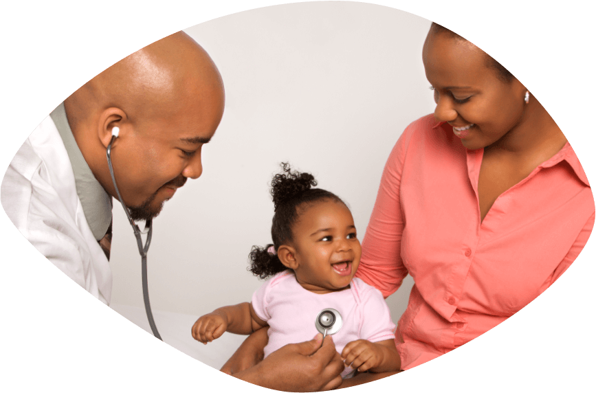 Smiling mother holding her toddler toward home visiting nurse who is reaching for the baby