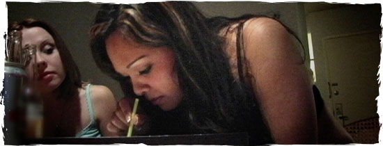 Woman snorting meth through a straw